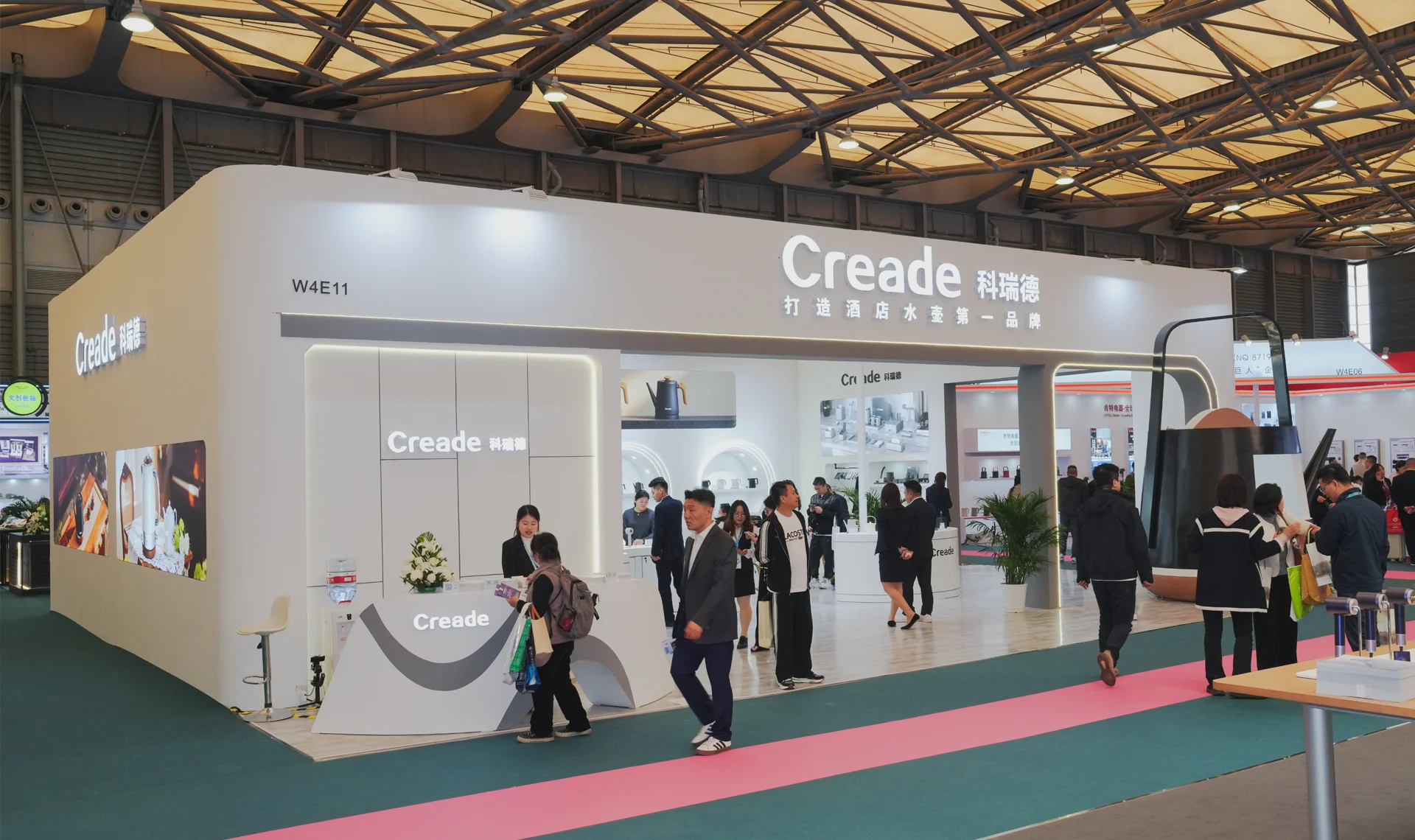 Creade exhibition booth with visitors and the exhibition team